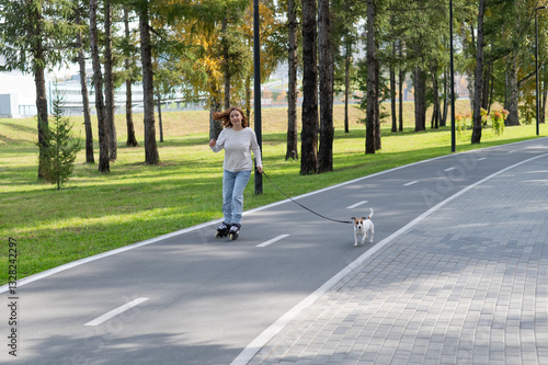 Wallpaper Mural Caucasian woman roller skating with her jack russell terrier dog in park.  Torontodigital.ca