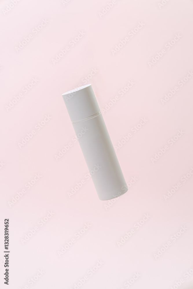 Floating White Cosmetic Bottle on Soft Pink Background Floating White Cosmetic Bottle on Soft Pink Background