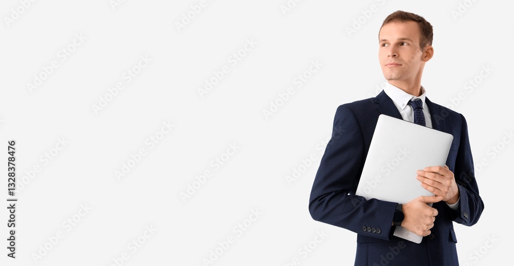 Handsome businessman in suit and with laptop on light background with space for text Handsome businessman in suit and with laptop on light background with space for text