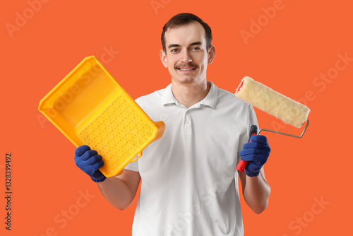 Young man with paint roller...