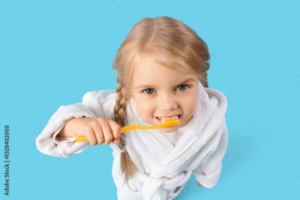 Cute little girl brushing teeth on blue background Cute little girl brushing teeth on blue background