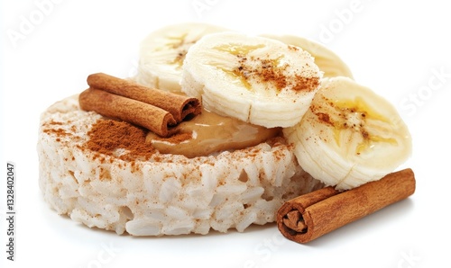 Healthy Snack Arrangement of Rice Cake Topped with Peanut Butter, Fresh Banana Slices, and Sprinkled Cinnamon Sticks for a Nutritious Treat