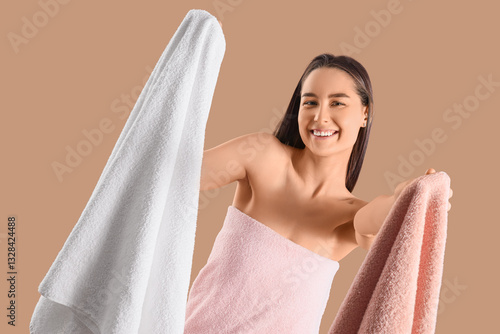 Smiling young woman wrapped...