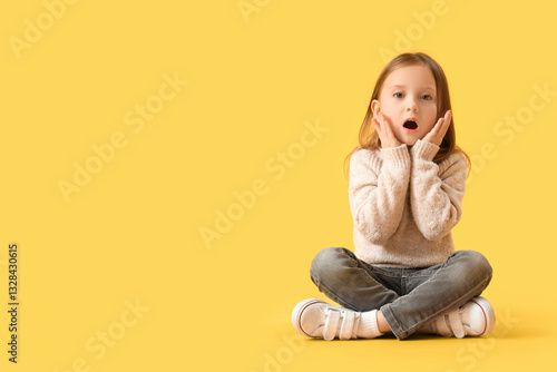Shocked little girl sitting...