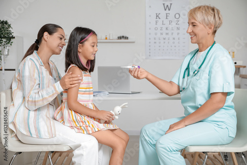 Female pediatrician giving ...