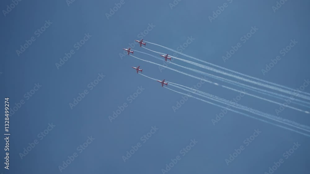 Surya Kiran Aerobatic team performing in the sky during Aero India, showcasing aerial stunts Surya Kiran Aerobatic team performing in the sky during Aero India, showcasing aerial stunts