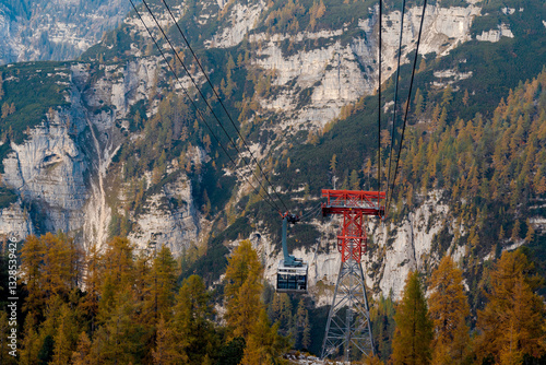 Ski lift crossing through the mountains during the autumn day photo