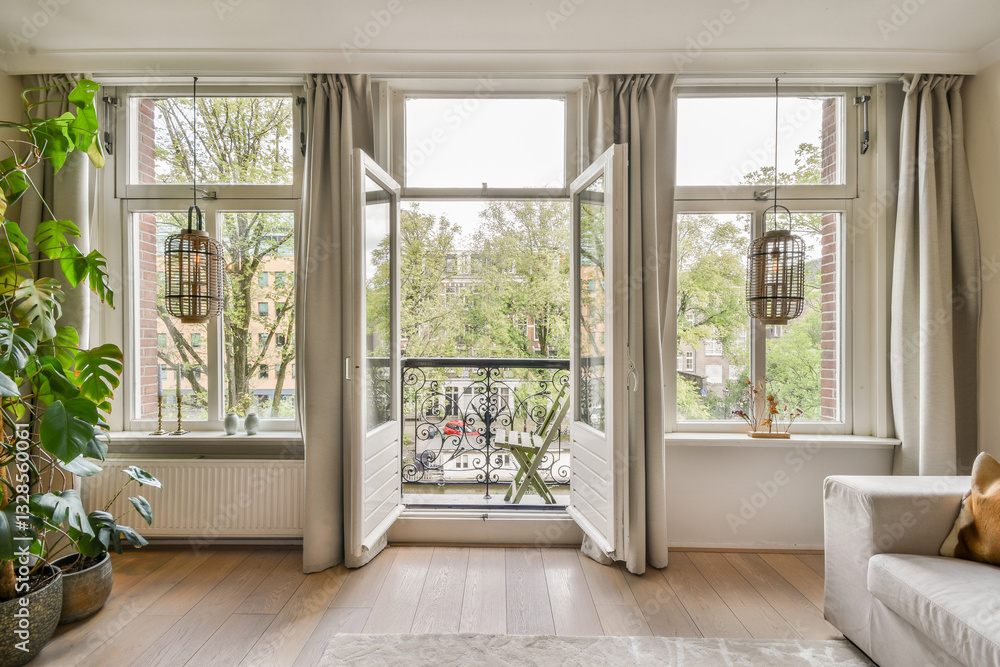 Fototapeta premium A serene modern living room featuring large windows that invite natural light and showcase a view of greenery outside. Indoor plants enhance the cozy atmosphere.
