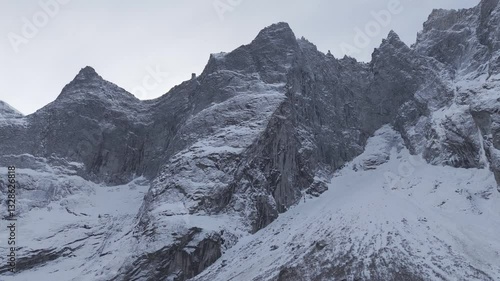 Wallpaper Mural Backwards drone shot flying underneath Troll Wall or Trollveggen in Norway with trees in the forground looking at the snowy mountain tips on a bright day near sunrise LOG Torontodigital.ca