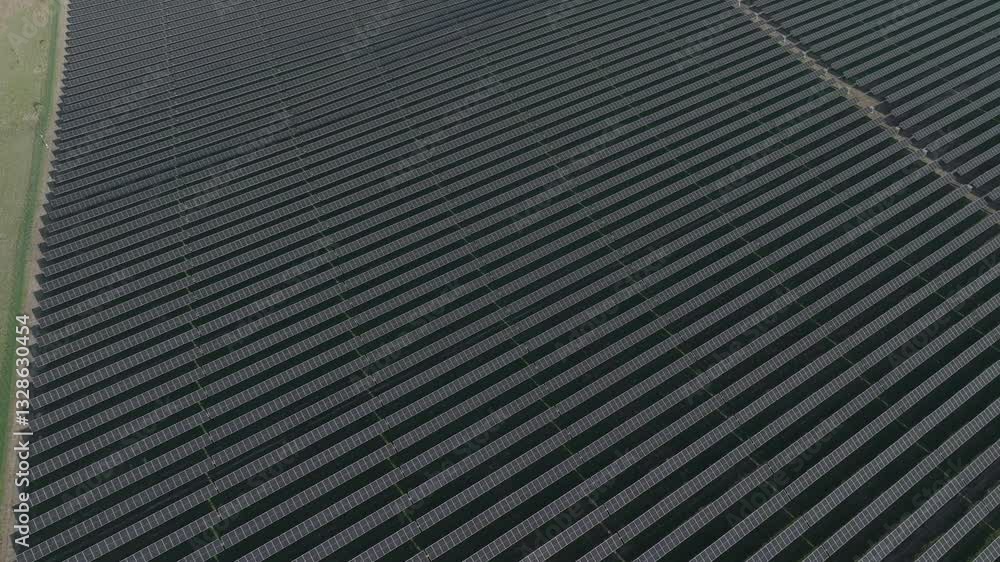A large solar farm, rows of solar panels forming a grid structure, aerial view A large solar farm, rows of solar panels forming a grid structure, aerial view
