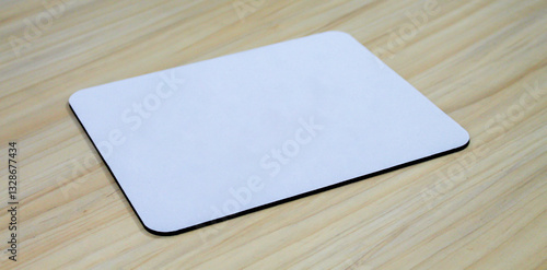 Photos blank square mouse pad on wooden table