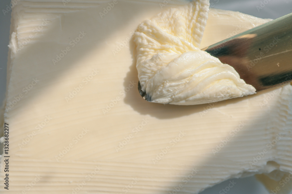 custom made wallpaper toronto digitalClose-up of a knife spreading fresh butter with soft curls forming on the blade. Warm natural light highlights the creamy texture, creating a rustic and appetizing food scene
