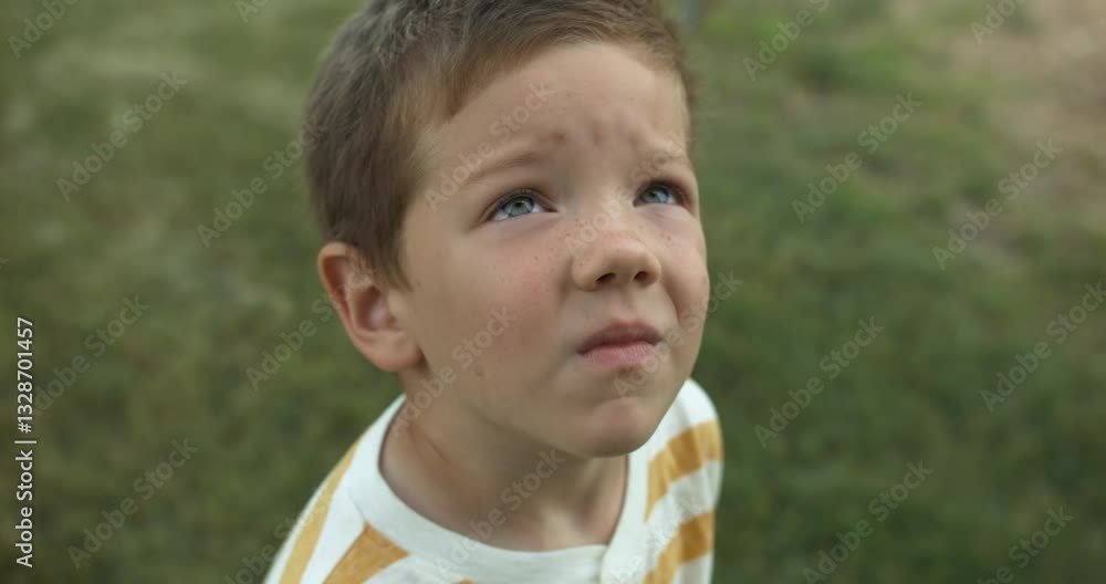 Closeup of the face of a young boy, child, as he gazes up at the sky in slow motion, his eyes full of wonder and curiosity. This cinematic footage captures the innocence and imagination of childhood. Closeup of the face of a young boy, child, as he gazes up at the sky in slow motion, his eyes full of wonder and curiosity. This cinematic footage captures the innocence and imagination of childhood.