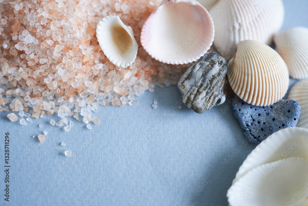 Sea salt and seashells on blue background, close-up Sea salt and seashells on blue background, close-up