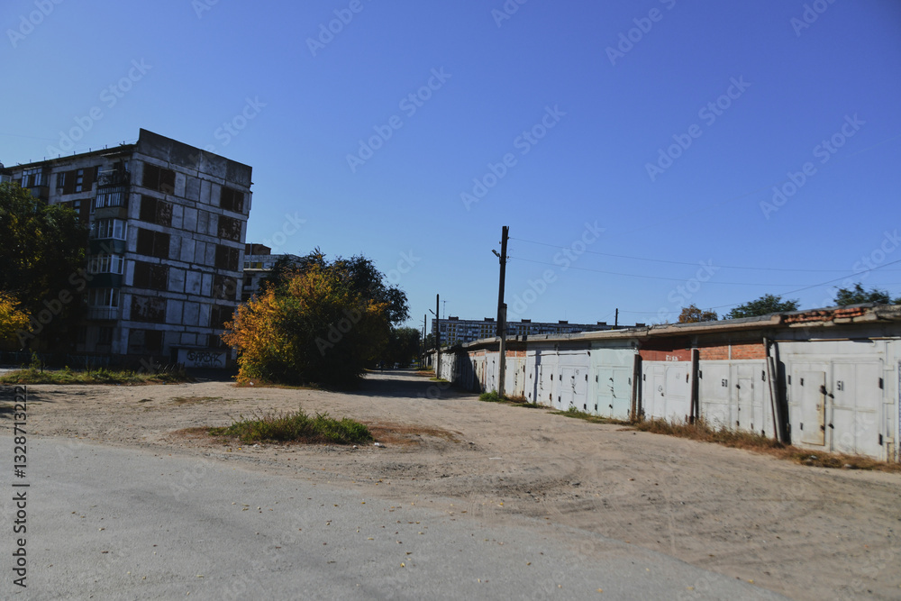 Autumn landscape of a small town. Village houses and roads covered with orange foliage Autumn landscape of a small town. Village houses and roads covered with orange foliage