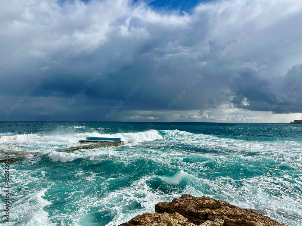 Storm in the Mediterranean Sea and waves crashing on the beach in Sliema, Malta