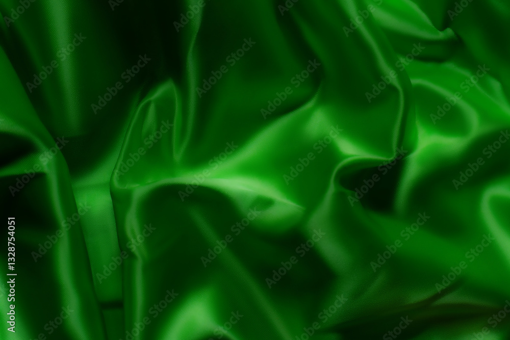 Obraz premium Vibrant green silky fabric with smooth folds and glossy texture. Ideal for luxury fashion, textile design, branding, nature-inspired themes, digital art, and eco-friendly product backgrounds
