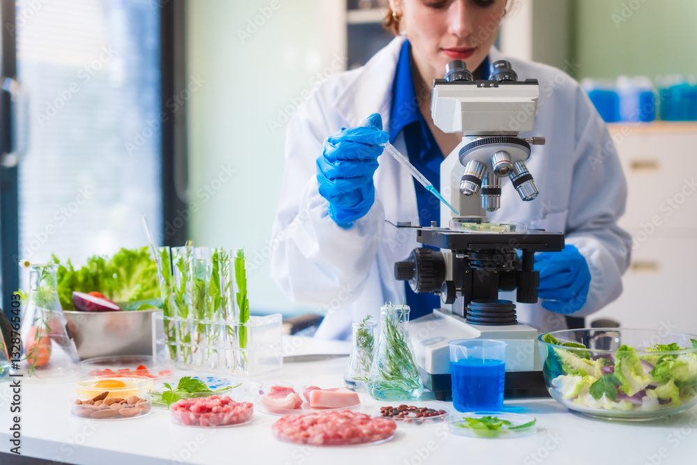 Fototapeta premium Middle-aged female laboratory worker wearing blue gloves conducts lab test on food ingredients lettuce, cucumber, pork. Using microscope, she analyzes nutrients, preservatives, food safety records.