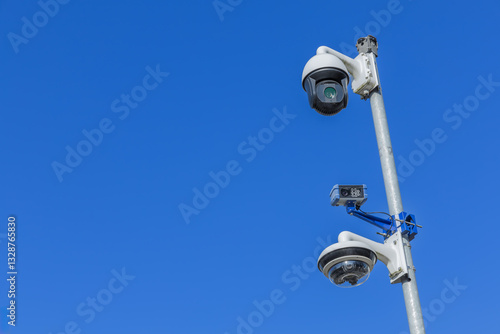 Three surveillance cameras on a pole, a high resolution camera with night vision, automatic number plate recognition (ANPR) and a 360 panoramic view camera.
