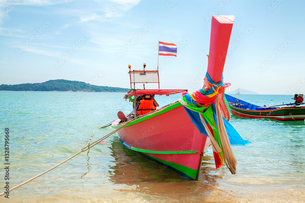 Longtale boat on the beach at Phuket, Thailand. View of tropical beach near Phuket in Thailand. Travel summer concept. Vacation holidays summer background. Sea wooden boat in Thailand.