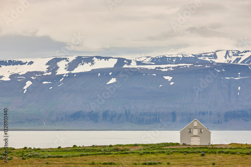 Traditional wooden icelandic solitary house near a fjord. Iceland