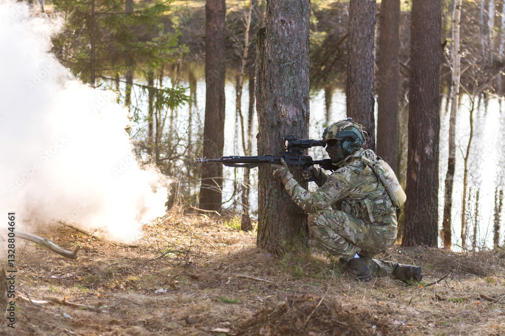 Fototapeta premium Soldiers in the forest. Military men in camouflage with weapons.