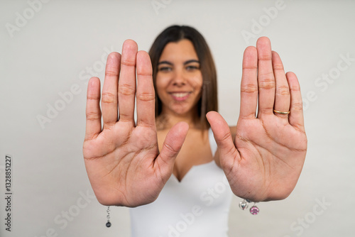 Canvas Print Young woman showing her palms and making stop sign with hands
