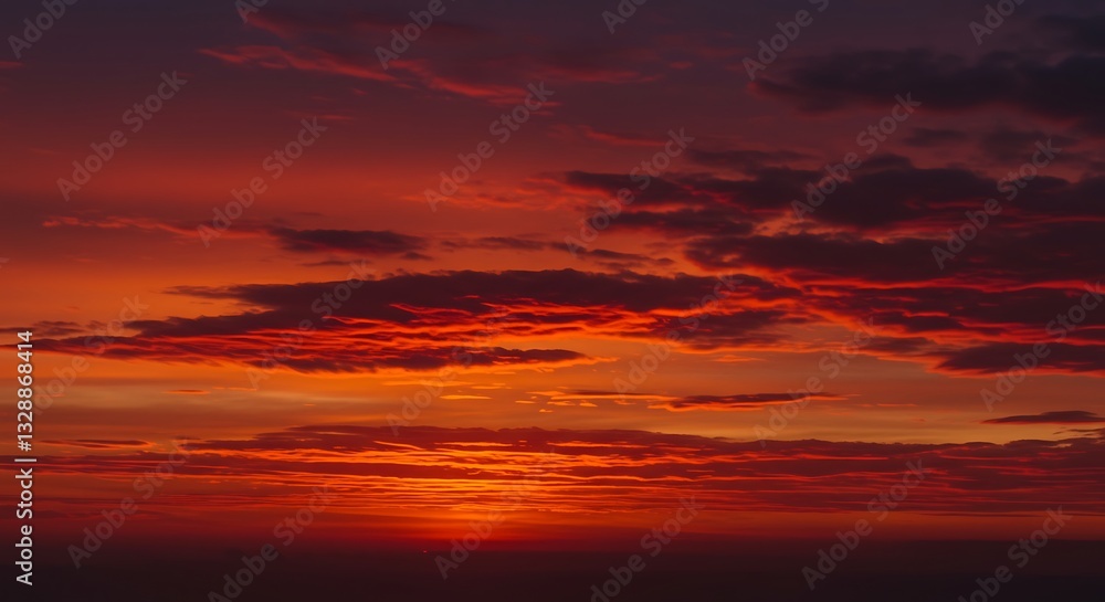 Fototapeta premium Fiery Sunset over Horizon: A breathtaking view of a vibrant sunset, painting the sky with fiery hues of red and orange, creating a dramatic and awe-inspiring spectacle.