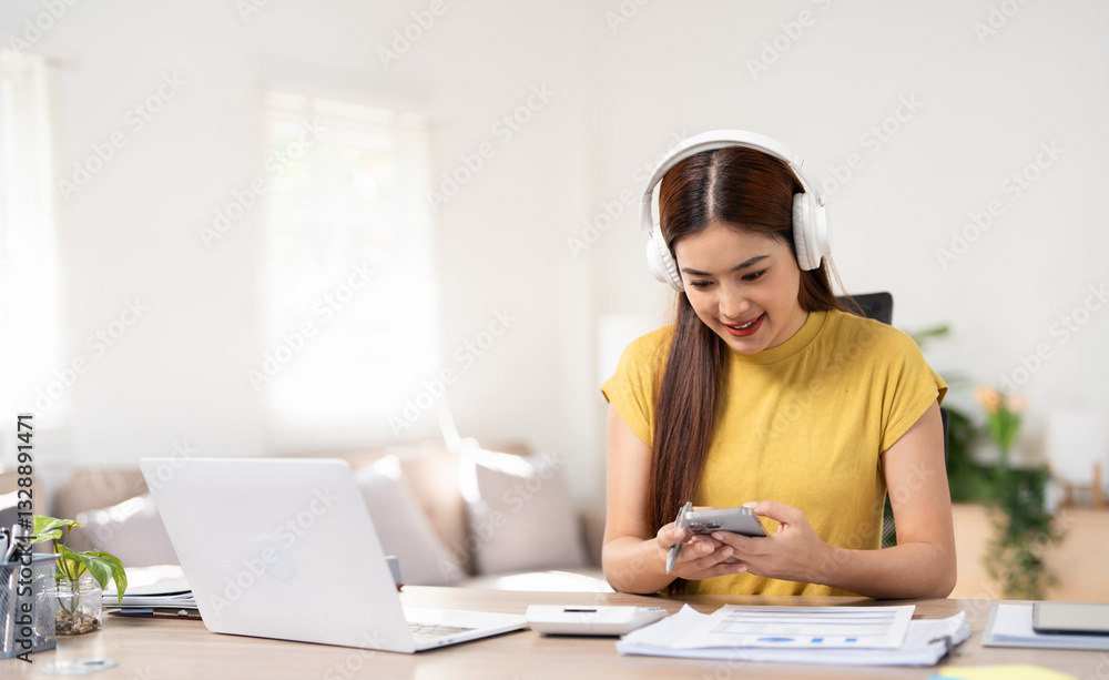 Smiling beautiful asian woman with stay home working in office desk using phone head set computer. Small business employee freelance online sme telemarketing concept. Smiling beautiful asian woman with stay home working in office desk using phone head set computer. Small business employee freelance online sme telemarketing concept.