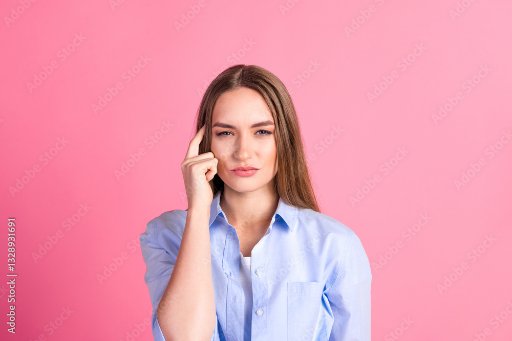 Young Woman in a Blue Shirt Expressing Thoughtful Gesture Against Bright Pink Background, Perfect for Lifestyle and Advertising Themes Young Woman in a Blue Shirt Expressing Thoughtful Gesture Against Bright Pink Background, Perfect for Lifestyle and Advertising Themes