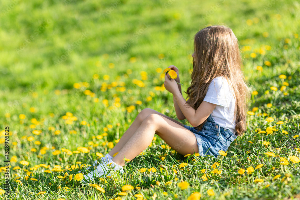 Portrait of little cute girl sitting with dandelions on the grass. Happy smiling girl lies on the grass among yellow flowering dandelions in the park. Spring concept. Happy life without allergy. Portrait of little cute girl sitting with dandelions on the grass. Happy smiling girl lies on the grass among yellow flowering dandelions in the park. Spring concept. Happy life without allergy.