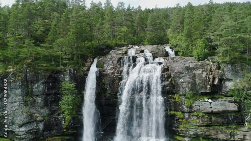 Majestic Tvinde Norwegian waterfall cascading over forest rock formations, drone Majestic Tvinde Norwegian waterfall cascading over forest rock formations, drone