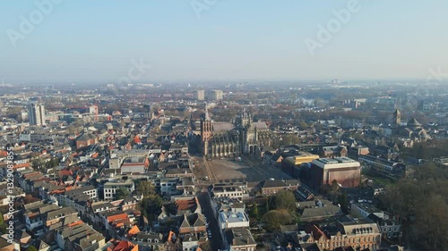 Beautiful jib down of the Den Bosch city skyline with the St. John's Cathedral prominently centered in the city on a sunny day