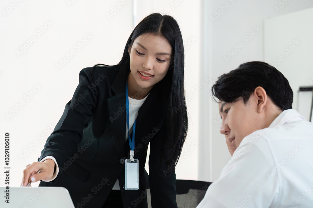 Professional Development and Teamwork. A woman presents ideas to a colleague during a collaborative meeting in a modern office. Professional Development and Teamwork. A woman presents ideas to a colleague during a collaborative meeting in a modern office.