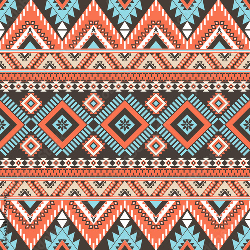 Abstract ethnic geometric texture pattern. Seamless blue and gold color of tribal abstract fabric textile on brown and orange background