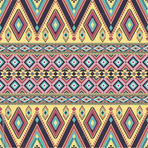Abstract ethnic geometric texture pattern. Seamless pink and blue color of tribal abstract fabric textile on pastel yellow background