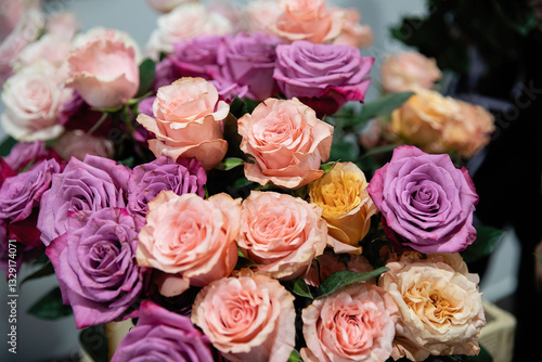 Bouquet of flowers from roses of different colors. Pink and purple roses.