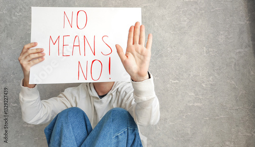 Portrait of a young confident woman holding a banner saying 