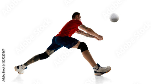 Obraz na plátne Young guy in red jersey and blue shorts, volleyball player in motion during intense game, training, playing against white studio background