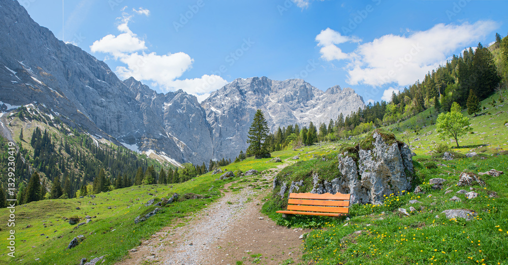 hiking trail to Hohljoch mountain, wooden bench beside. Karwendel alps view tyrol
