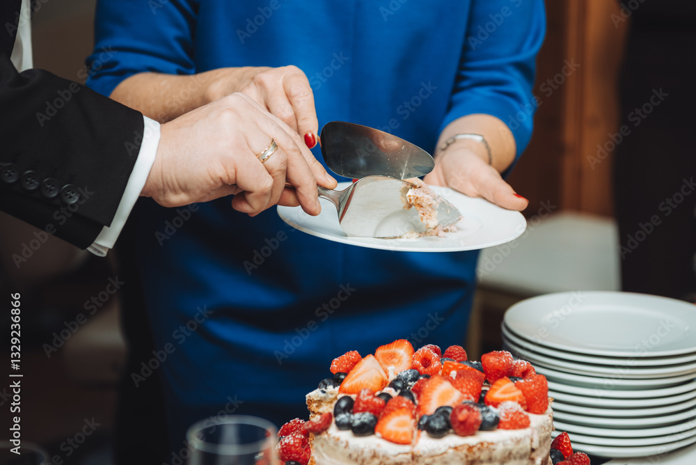Festive cake with white cream, decorated with raspberries and strawberries