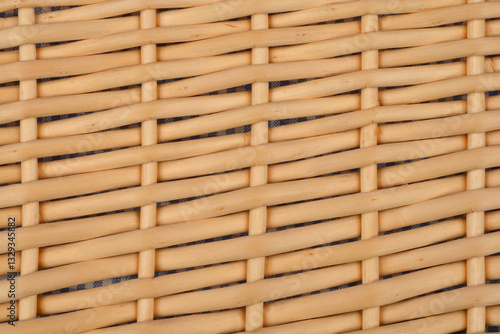 A close-up shot of woven rattan with a visible underlying fabric, creating a textured pattern