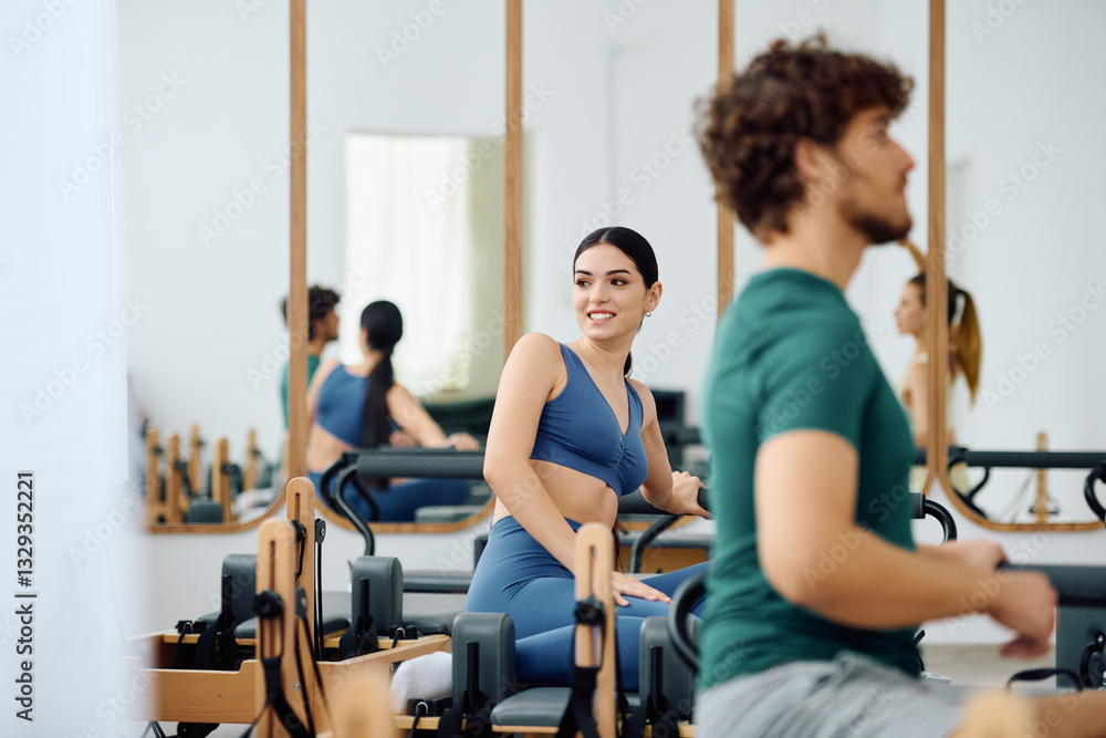 Obraz premium Engaging pilates session in a vibrant studio with motivated participants on a sunny day