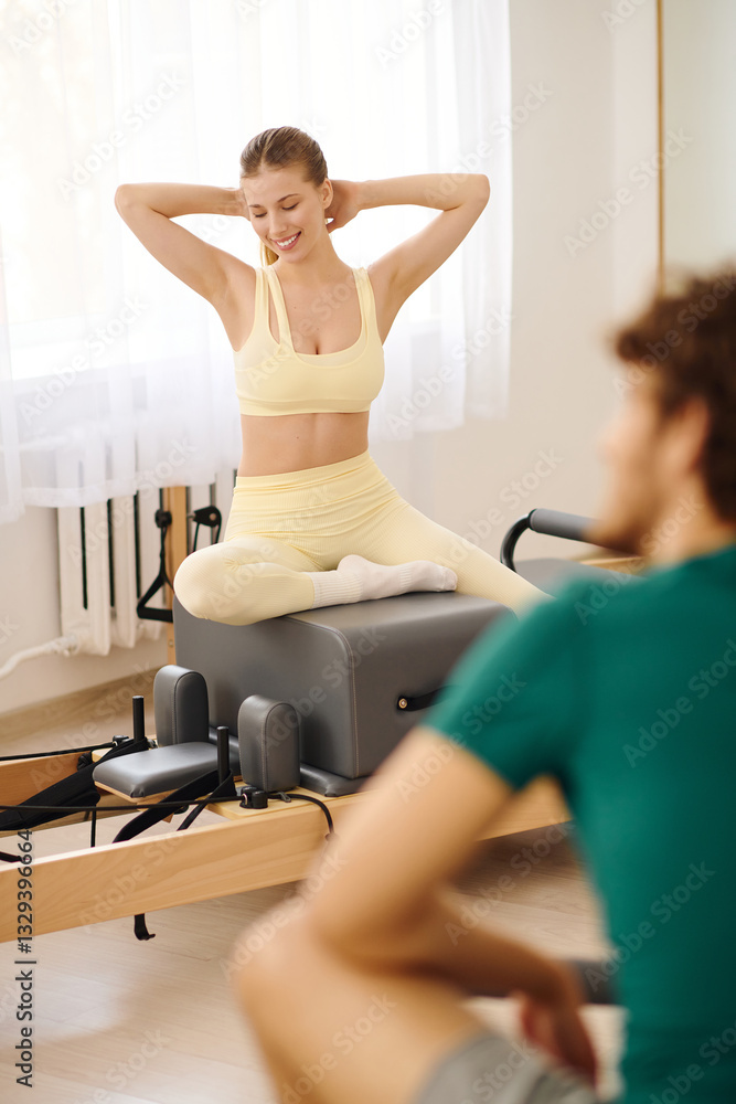 Relaxing and stretching in a bright pilates studio during a vibrant workout session Relaxing and stretching in a bright pilates studio during a vibrant workout session