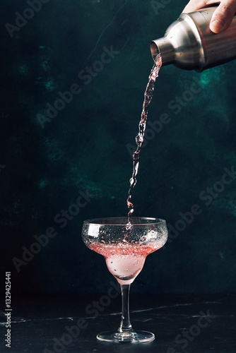 Male hand pour cocktail or mocktail into cocktail glass. Alcoholic soft drink in nightclub