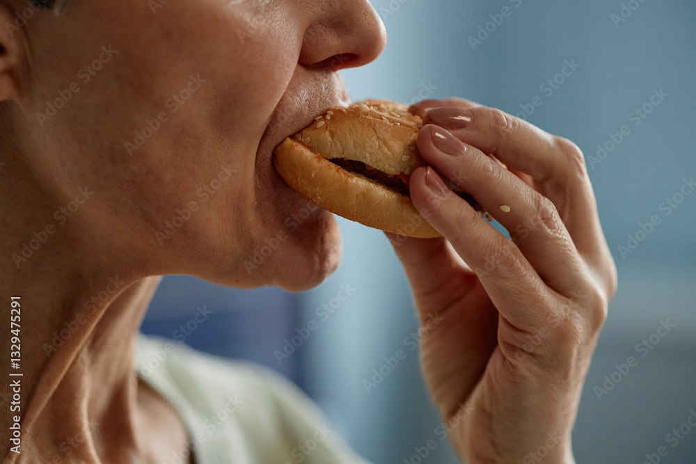 Close-up view of someone biting into delicious sandwich, focusing on tender hands and mouth as they savor flavors of the meal Close-up view of someone biting into delicious sandwich, focusing on tender hands and mouth as they savor flavors of the meal