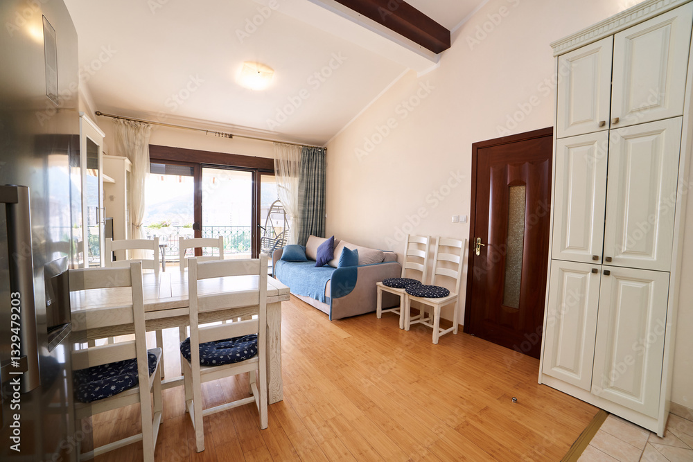 Spacious dining room with a large fold-out sofa, table, chairs, double-door refrigerator and wardrobe Spacious dining room with a large fold-out sofa, table, chairs, double-door refrigerator and wardrobe