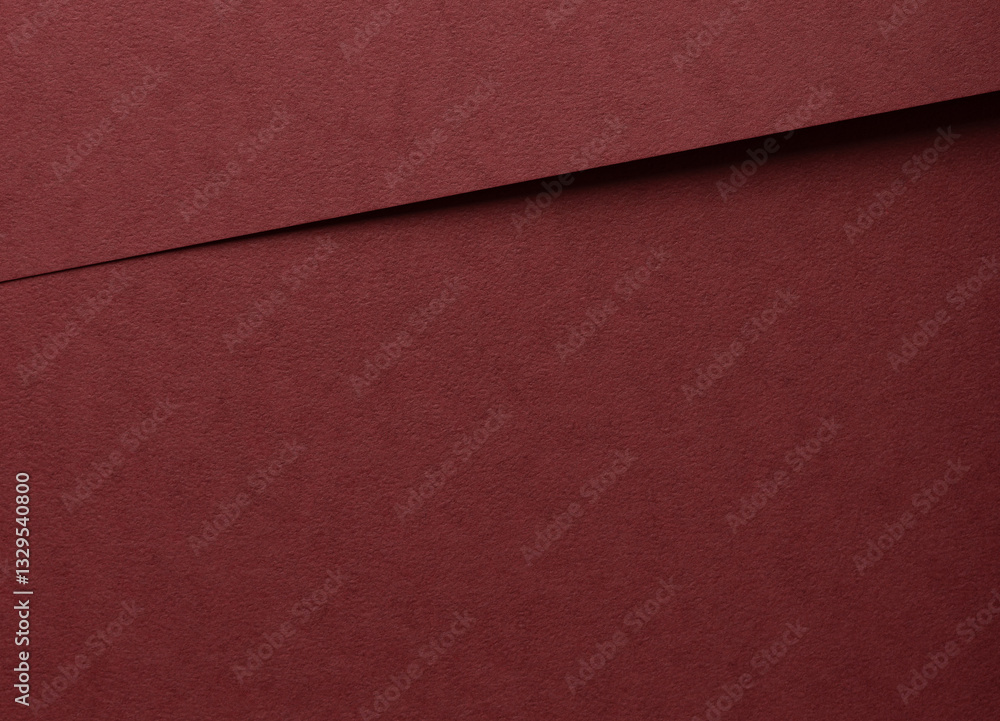 Fototapeta premium Deep burgundy paper background with a matte, grainy texture and subtle fibrous surface. Elegant red tones and minimalistic design create a luxurious, premium finish, ideal for designer paper and.