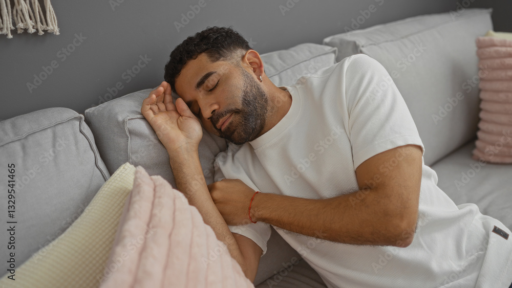 Young man sleeping on a couch in a cozy living room, showcasing a peaceful, relaxed indoor environment with soft pillows and neutral decor, reflecting comfort and rest. Young man sleeping on a couch in a cozy living room, showcasing a peaceful, relaxed indoor environment with soft pillows and neutral decor, reflecting comfort and rest.