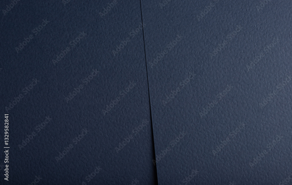 Fototapeta premium Navy blue paper background with a matte, fibrous texture and subtle perforated details. Deep, rich tones and geometric patterns create an elegant, luxury design, perfect for high-end stationery or.